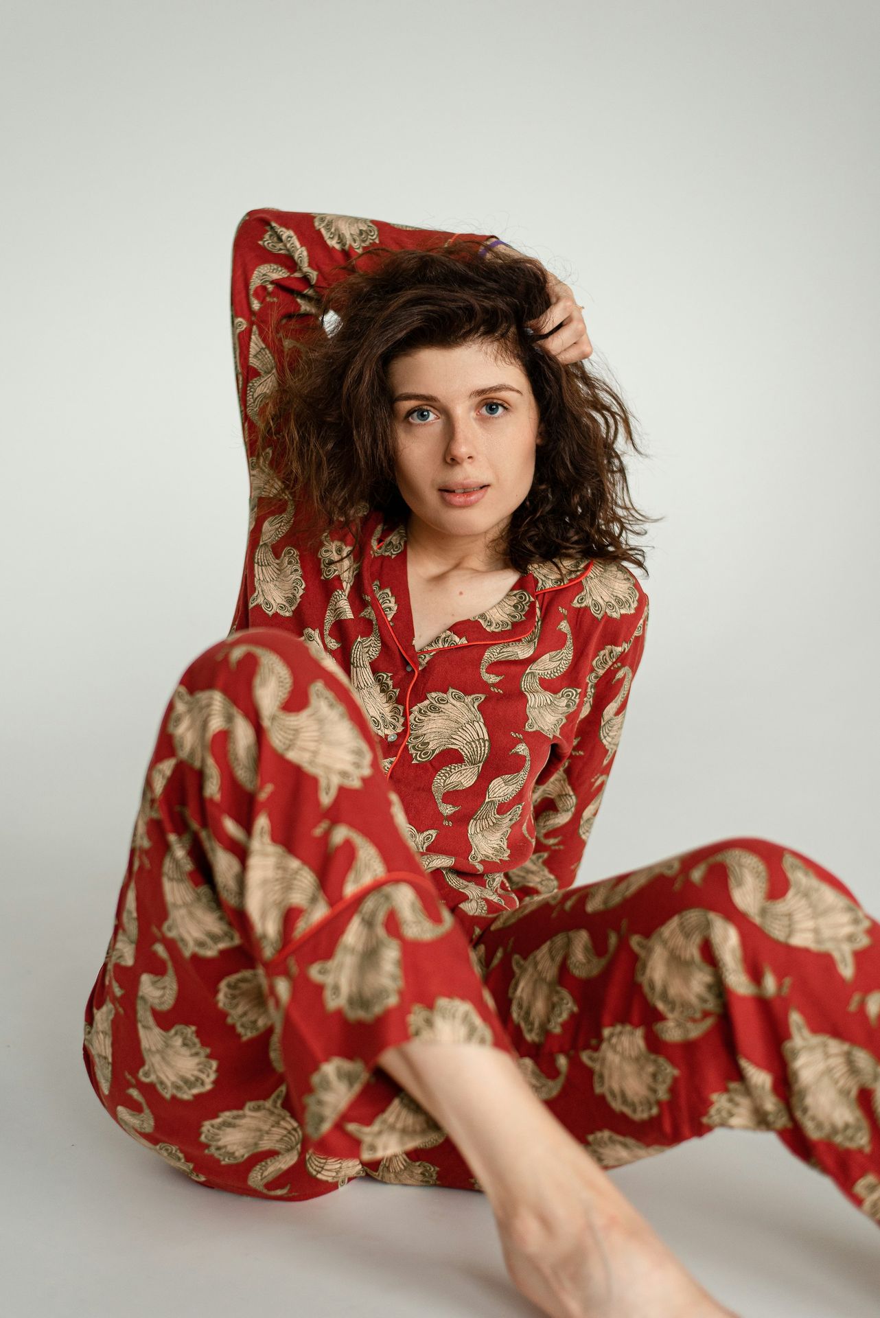 a woman in a red and gold pajama set